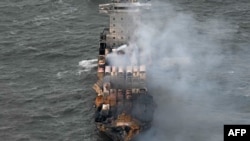 Smoke rises from damaged containers on the deck of the MV Solong cargo ship in the North Sea, off the coast of Withernsea, east of England, on March 11, 2025, after it collided with the MV Stena Immaculate tanker on March 10. 