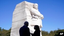 President Joe Biden and Vice President Kamala Harris stand together at the Martin Luther King Jr. Memorial as they arrive to attend an event marking the 10th anniversary of the dedication of memorial in Washington, Oct. 21, 2021.