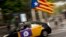 A man drives his taxi decorated with an estela flag and publicity supporting the Oct. 1 vote in Barcelona, Spain Friday, Sept. 22, 2017.