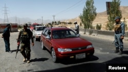 Afghan security forces keep watch at a checkpoint on the Ghazni highway, in Maidan Shar, the capital of Wardak province, Afghanistan, Aug. 12, 2018.