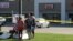 Zach, Zoe and Melissa Cates add to a makeshift memorial near the scene of a shooting at a Armed Forces Career Center/National Guard recruitment office in Chattanooga, Tennessee, July 16, 2015.