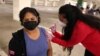 Maria Meza, 43, is given a coronavirus disease (COVID-19) vaccination in Los Angeles, California, U.S., April 12, 2021. 