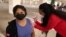 Maria Meza, 43, is given a coronavirus disease (COVID-19) vaccination in Los Angeles, California, U.S., April 12, 2021. 