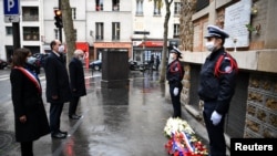 Paris Mayor Anne Hidalgo and French Prime Minister Jean Castex pay tribute outside La Belle Equipe bar to the victims of the November 2015 jihadist attacks in which 130 people were killed, in Paris, France, Nov. 13, 2020. 