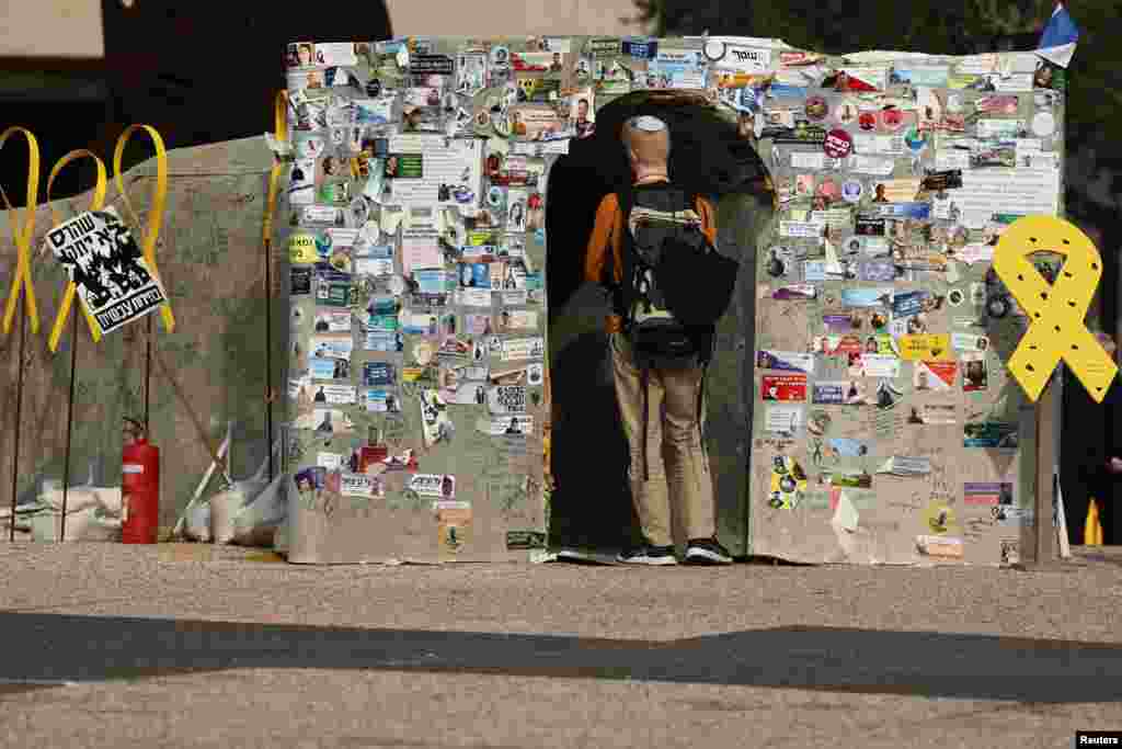 A person enters a makeshift tunnel symbolizing Hamas tunnels, built in support of the hostages kidnapped during the deadly October 7, 2023 attack by Hamas and who are still held in captivity, at the so-called &quot;Hostages Square&quot; in Tel Aviv, Israel.