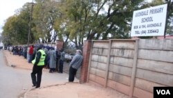 Voters queue to cast their ballots on July 31, 2013. ZEC says more than 300,000 voters across the country were turned away.