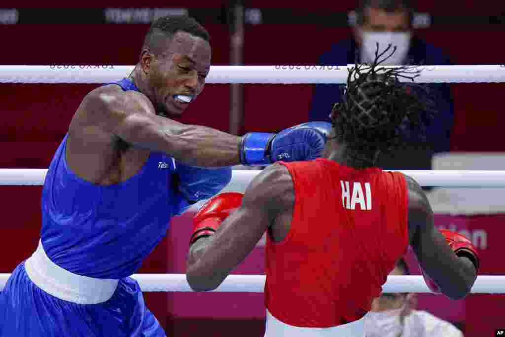 Haiti&#39;s Darrelle Valsaint Jr., right, takes a punch from David Tshama Mwenekabwe, of the Democratic Republic of the Congo, during their men&#39;s middleweight 75-kg boxing match at the 2020 Summer Olympics, Thursday, July 29, 2021, in Tokyo, Japan. (AP Photo/Frank Franklin II)