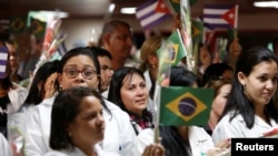 Cuban doctors take part in a welcoming ceremony at the Jose Marti International Airport after arriving from Brazil, in Havana, Cuba, Nov. 23, 2018.