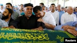 Relatives of Kumri Ilter, one of the victims of Saturday's suicide bombing at a wedding, mourn during her funeral ceremony in southeastern city of Gaziantep, Turkey, Aug. 22, 2016. 