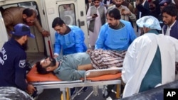 Paramedics and volunteers transport an injured victim of a bomb explosion in Mastung town, upon arrival at a hospital in Quetta, Pakistan, Nov. 1, 2024.