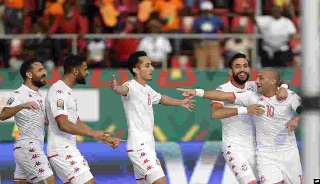 Tunisia's Wahbi Khazri, right, celebrates with teammates after scoring his team's second goal, during the soccer match between Tunisia and Mauritania; Cameroon, Jan. 16, 2022.