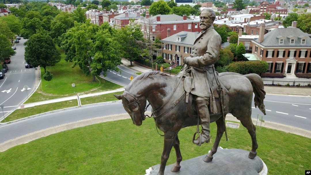 FILE - The statue of Confederate Gen. Robert E. Lee stands in the middle of a traffic circle on Monument Avenue in Richmond, Virginia.