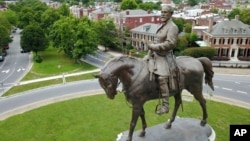 FILE - The statue of Confederate Gen. Robert E. Lee stands in the middle of a traffic circle on Monument Avenue in Richmond, Virginia.