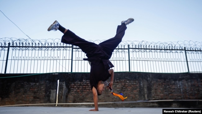 A Kung Fu nun practices before her performance at Druk Amitabha Mountain Nunnery in Kathmandu, Nepal December 30, 2024.