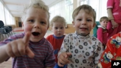 Kids look on in the Republican Hospital for Infectious Diseases, which specializes in treating HIV-positive children in Ust-Izhora outside St. Petersburg, Russia, May 30, 2006. 