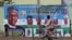 FILE PHOTO: A cyclist rides past a campaign poster for President Muhammadu Buhari days before the presidential election in Kano, Nigeria, Feb. 17, 2019. 