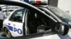 FILE - A New Orleans police officer leans against a patrol car, Sept. 11, 2005. 