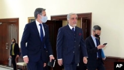 Abdullah Abdullah, chairman of the High Council for National Reconciliation, center, walks with U.S. Secretary of State Antony Blinken, at the Sapidar Palace in Kabul, Afghanistan, April 15, 2021.