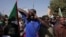 FILE: Tens of thousands of Sudanese calling for a civilian government march near the presidential palace in Khartoum, Sudan, Tuesday, Nov. 30, 2021