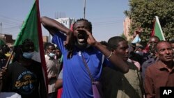 FILE: In one of hundreds of demonstrations since the military coup, tens of thousands of Sudanese calling for a civilian government march near the presidential palace in Khartoum, Sudan. Taken 11.30.2021