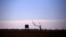 FILE - A dead tree stands near a water tank in a drought-stricken paddock located on the outskirts of the southwestern Queensland town of Cunnamulla in outback Australia, Aug. 10, 2017.