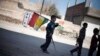 FILE - A boy carries a Kurdish flag on a street in Ras al-Ayn, Syria, Feb. 26, 2013. Taking advantage of the chaos of the civil war, Syria’s Kurdish minority has carved out a once unthinkable independence in their areas, even going public with their language and culture.