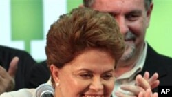 Brazil's President-elect Dilma Rousseff, of the Workers Party, gestures to supporters as she arrives to give her victory speech after winning the election runoff in Brasilia, Brazil, Sunday Oct. 31, 2010.