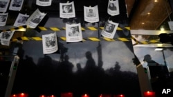 FILE - Photos of slain journalists are posted during a 2022 vigil in Mexico. On Sept. 25, 2023, journalist Jesús Gutiérrez was killed in northern Mexico. Mexico is one of the deadliest places in the world for journalists outside a war zone.