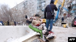 Toys are seen on the ground as part of a makeshift memorial for the victims of a gas explosion at a residential building in Magnitogorsk, Russia, Jan. 2, 2019.