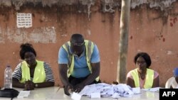TOPSHOT - An electoral worker sorts ballots during the counting of votes for Guinea-Bissau's presidential runoff on December 29, 2019, in Bissau. - Guinea-Bissau voters casted their ballots in a presidential runoff on December 29 with the hope of…