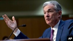 FILE - Federal Reserve Board Chair Jerome Powell testifies on Capitol Hill in Washington, July 17, 2018. Powell gives the keynote address Friday at an annual conference of central bankers in Jackson Hole, Wyo.