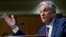 FILE - Federal Reserve Board Chair Jerome Powell testifies on Capitol Hill in Washington, July 17, 2018. Powell gives the keynote address Friday at an annual conference of central bankers in Jackson Hole, Wyo.