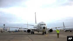 FILE - In this Oct. 23, 2019, image provided by the U.S. Navy, a P-8A Poseidon plane is seen during a pre-flight check, in Oak Harbor, Washington. China is rejecting a report that it fired a laser at a U.S. Navy P-8A Poseidon surveillance plane.