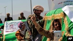 Houthi rebel fighters attend a funeral procession for Houthis who who were killed in recent fighting with forces of Yemen's Saudi-backed internationally recognized government, in Sana'a, Yemen, Feb. 16, 2021. 