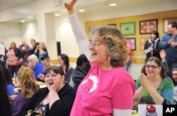 Bernie Sanders supporter Maryellen Lambert reacts at the Democratic Party caucus in Anchorage, Alaska, March 26, 2016.