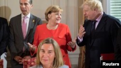 German Chancellor Angela Merkel, Britain's Foreign Secretary Boris Johnson, right, and Austria's Chancellor Christian Kern attend a summit of six Western Balkan countries in Trieste, Italy, July 12, 2017.