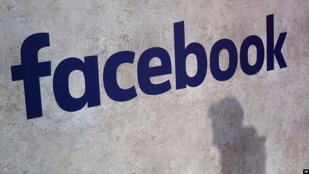 FILE - A Facebook logo is displayed at a start-up companies' gathering in Paris, France, Jan. 17, 2017. 