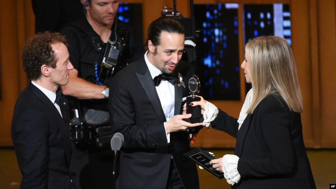 Barbra Streisand, right, presents the award for best musical to Lin-Manuel Miranda, center, of "Hamilton," as producer Jeffrey Seller looks on at the Tony Awards at the Beacon Theatre on Sunday, June 12, 2016.