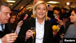 Marine Le Pen (C), France's far-right National Front political party leader, and National Front party deputy Gilbert Collard (L) attend the presentation of New Year wishes to the media in Nanterre, Jan. 7, 2014. 