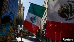 FILE - Mexican flags are displayed at a Hispanic Day Parade in New York.