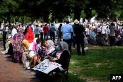 People gather in Lafayette Park, outside the White House in Washington, to protest against the deadly military raid on a nonviolent sit-in in Khartoum, Sudan, June 8, 2019.