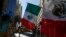 FILE - Mexican flags are displayed at a Hispanic Day Parade in New York.