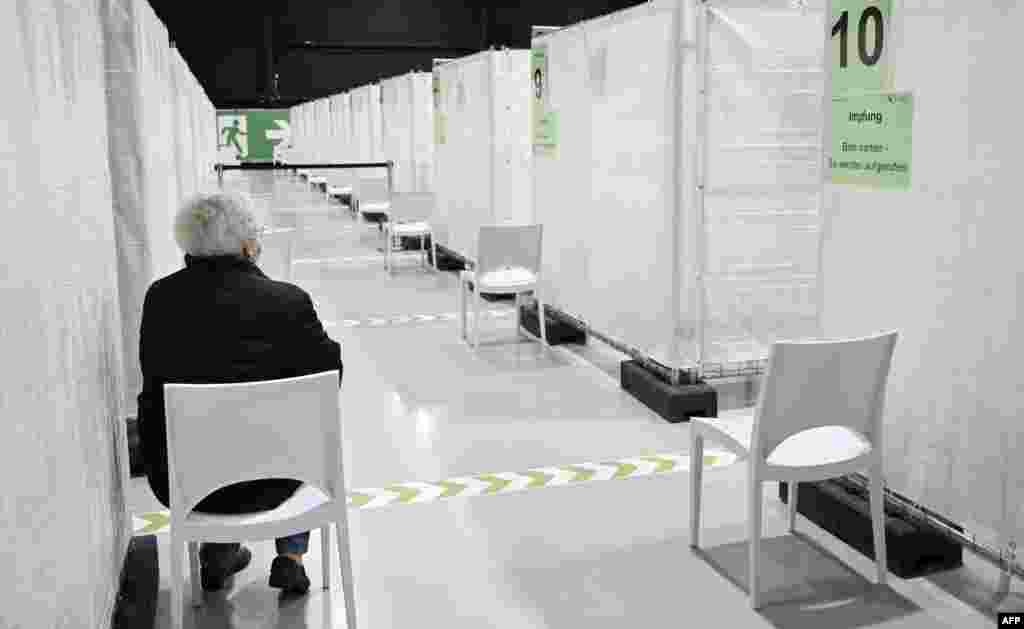 An elderly woman waits to be called for receiving the Pfizer-BioNTech COVID-19 vaccine at the regional corona vaccination center in Ludwigsburg, southern Germany.