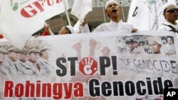 A Muslim Indonesian holds a banner during a protest in front of the Burma Embassy in Jakarta, Indonesia, July 13, 2012. 