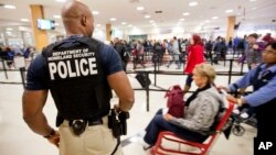 A Department of Homeland Security police officer stands at a security checkpoint at Hartsfield–Jackson Atlanta International Airport, Nov. 25, 2015. 