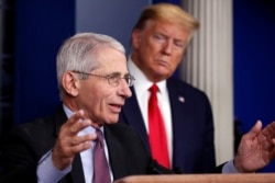 FILE - President Donald Trump watches as Dr. Anthony Fauci, director of the National Institute of Allergy and Infectious Diseases, speaks about the coronavirus in the James Brady Press Briefing Room of the White House, April 22, 2020.