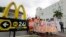 FILE - People protest for increased minimum wages outside a McDonald's restaurant in the Little Havana area in Miami, Florida, Dec. 4, 2014.