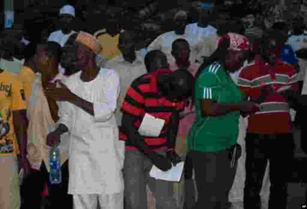 Voters and party agents recording election results at a polling station in Abuja, Nigeria's capital