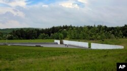 Visitors to the Flight 93 National Memorial visit the Wall of Names containing the names of the 40 passengers and crew of United Flight 93 that were killed in this field on Sept. 11, 2001, on May 31, 2018. 