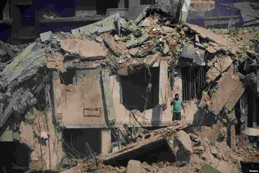 A civil defense member stands amid damage in the aftermath of what security sources said was an Israeli strike on a market in Nabatieh, southern Lebanon, amid the ongoing hostilities between Hezbollah and Israeli forces.